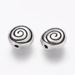 Kép 1/2 - Antikolt ezüst színű csigavonalas  lapított gyöngy (8x4mm)/4db